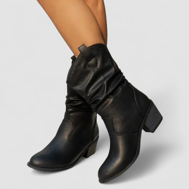 Eleanora slouch heeled boots in black, worn front view