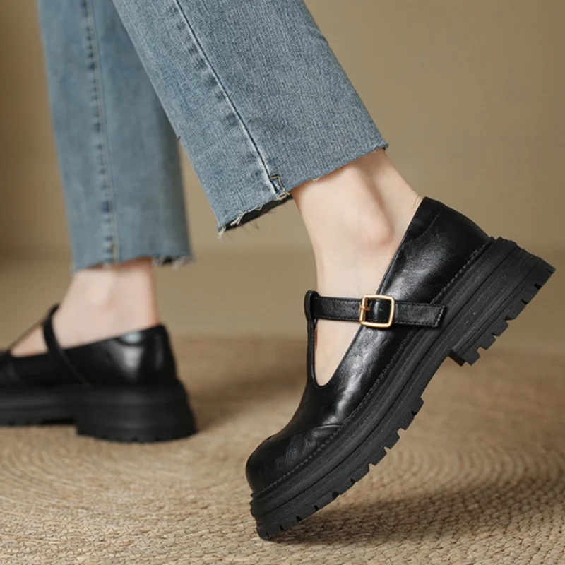 Luna classic T-bar shoes in black, worn with cropped jeans