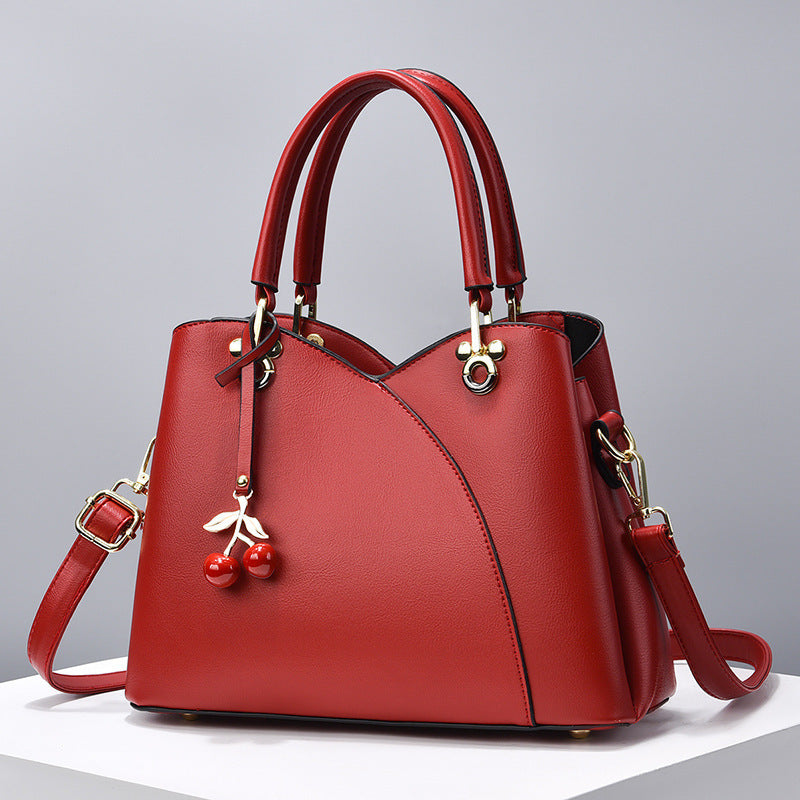 Avyra cherry tote bag in red, front view with detachable strap