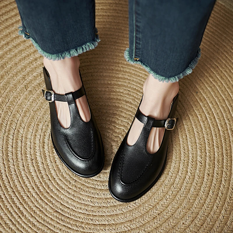 Laura T-strap pumps in black, top view with buckle detail