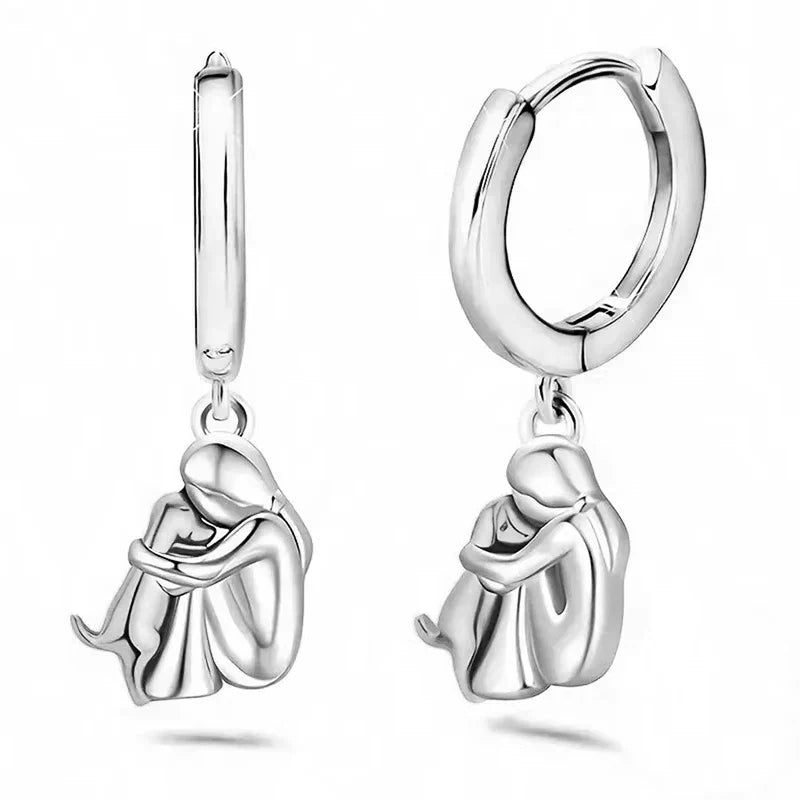 Seleno dog icon earrings in silver, pair shown upright