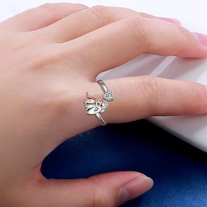 Embrace two-tone ring worn on a hand, close-up side view