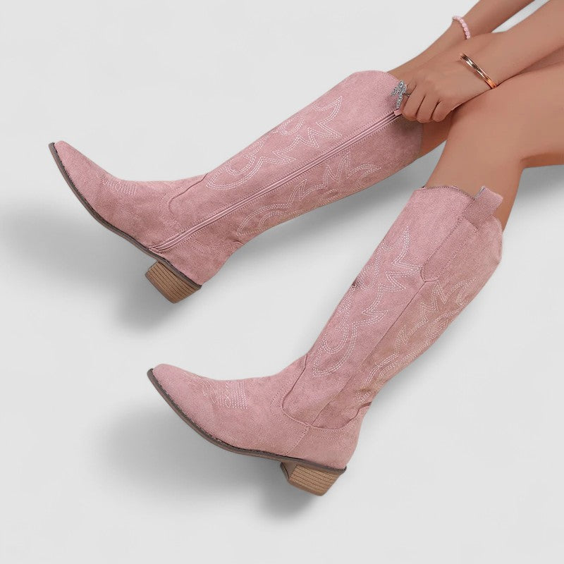 Cornelia western boots in pink, seated side view with block heel