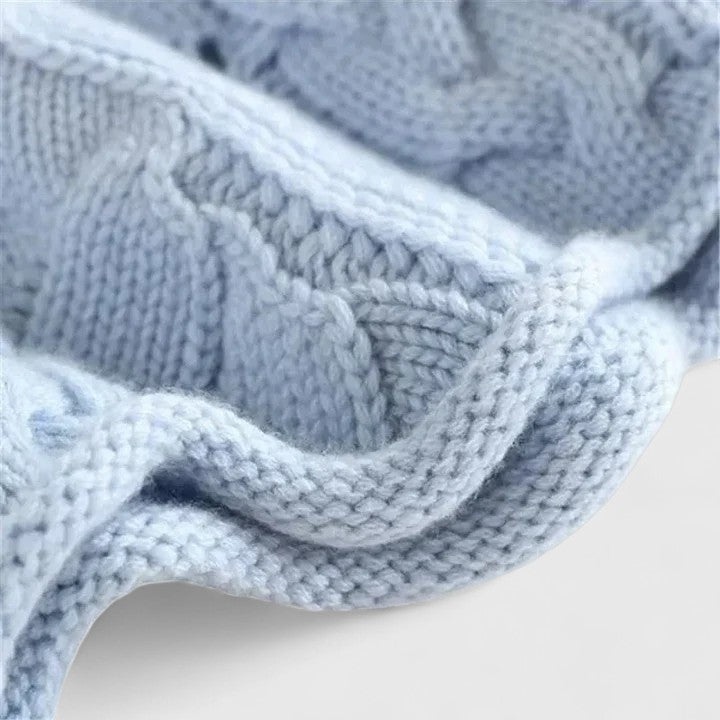 Zendrielle sweater in blue, close-up of ribbed hem and cable stitch
