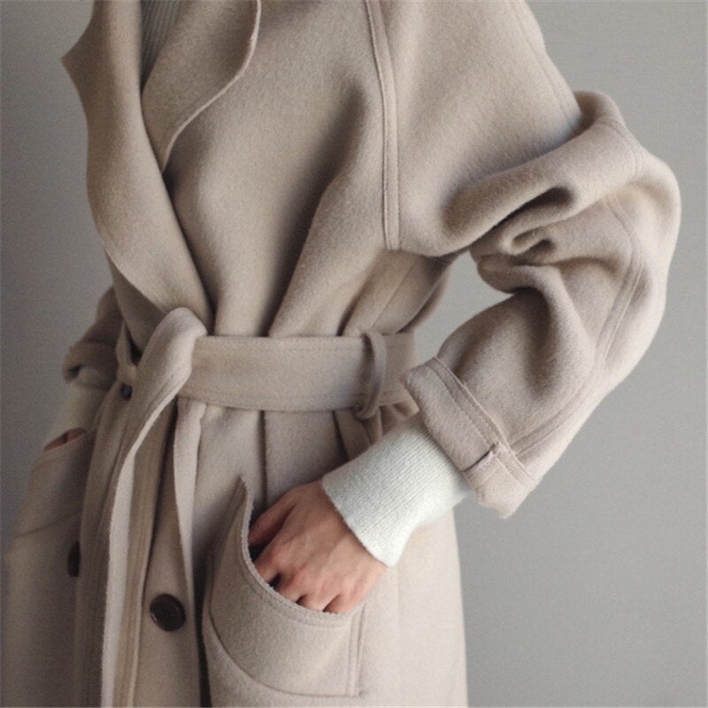 Cerys trench coat in off-white, close-up of belted waist and hip pocket