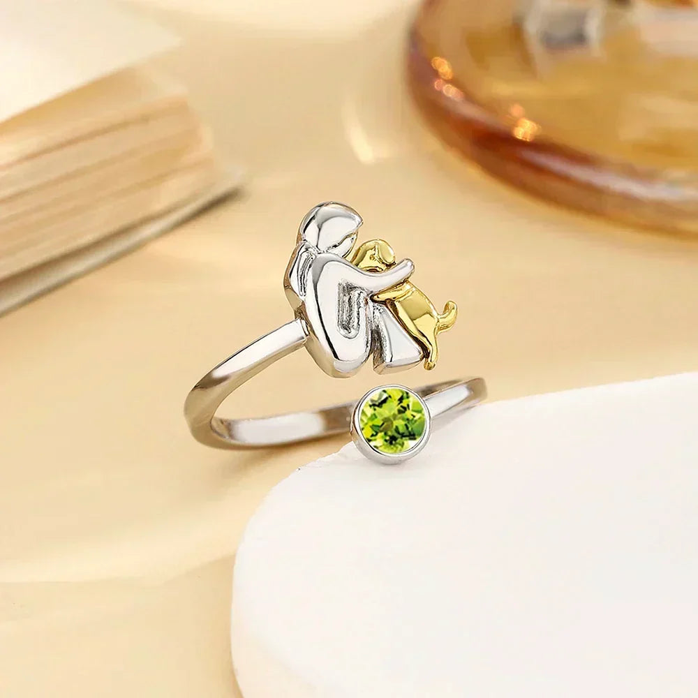 Vesporra dog icon ring with green gemstone, angled view