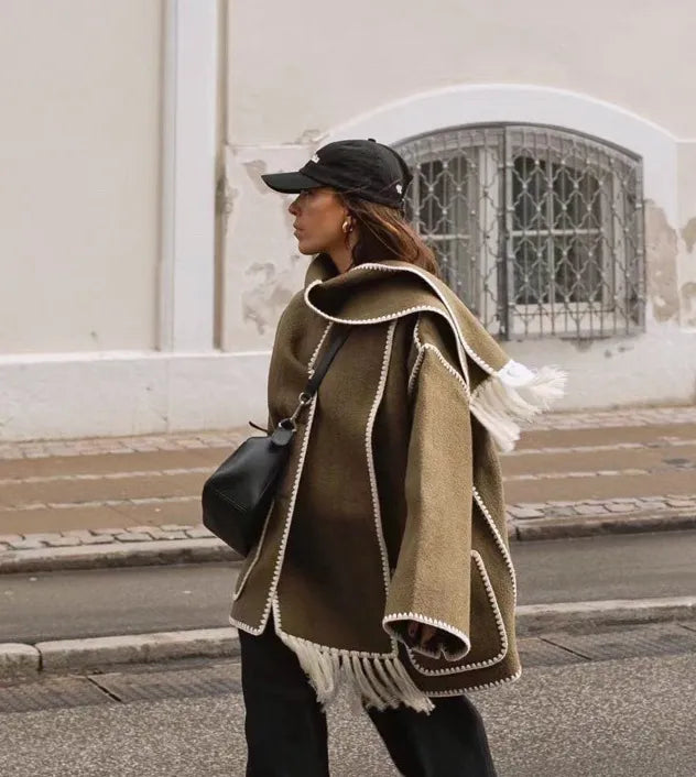 Zyra fringed scarf jacket in khaki brown, side view on model in the street