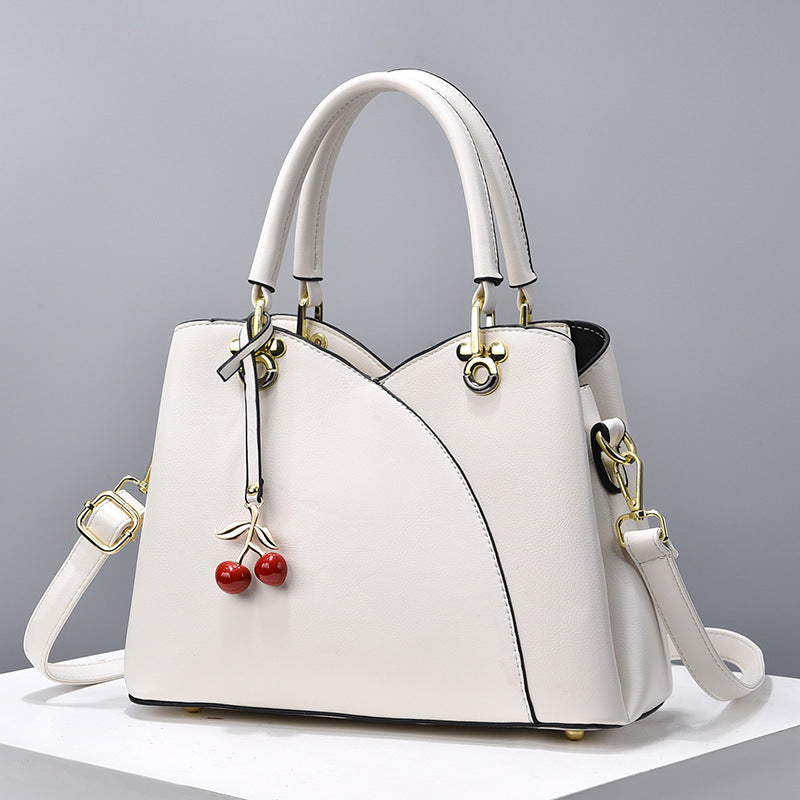 Avyra cherry tote bag in white, front view with gold hardware