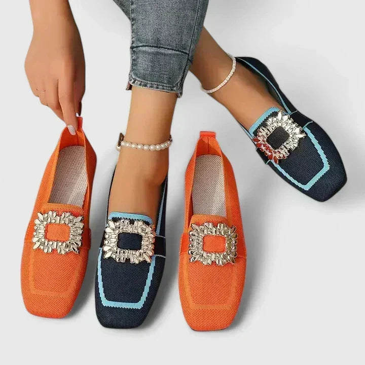 Grace loafers in orange and blue, worn and held side by side