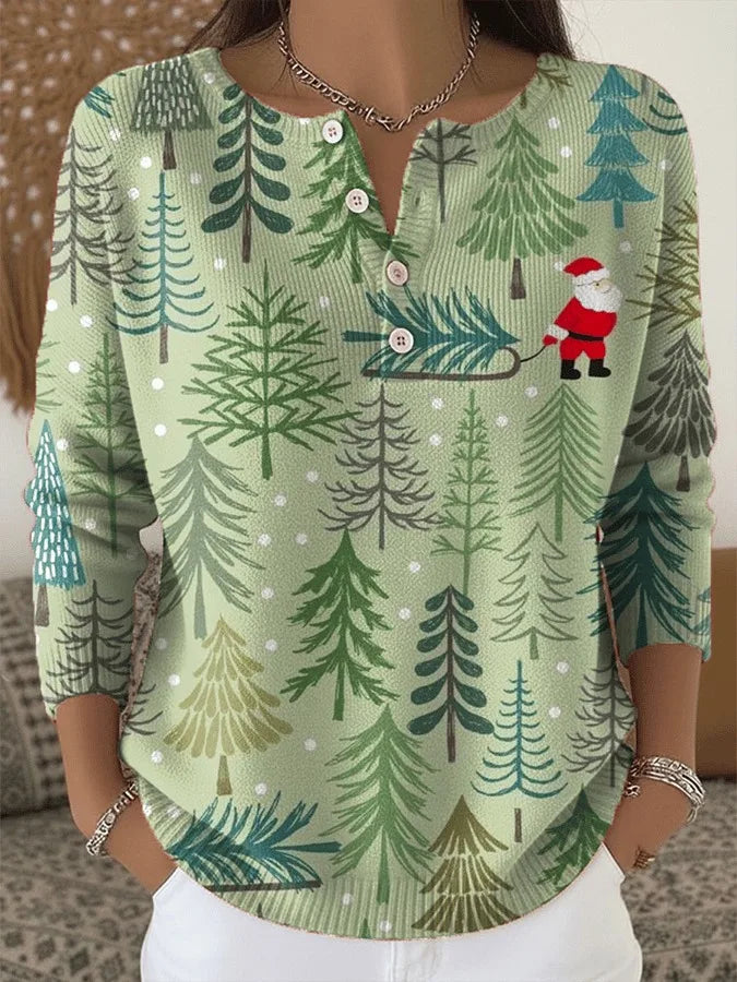 Anwen Christmas jumper in light green with forest and Santa print, front view