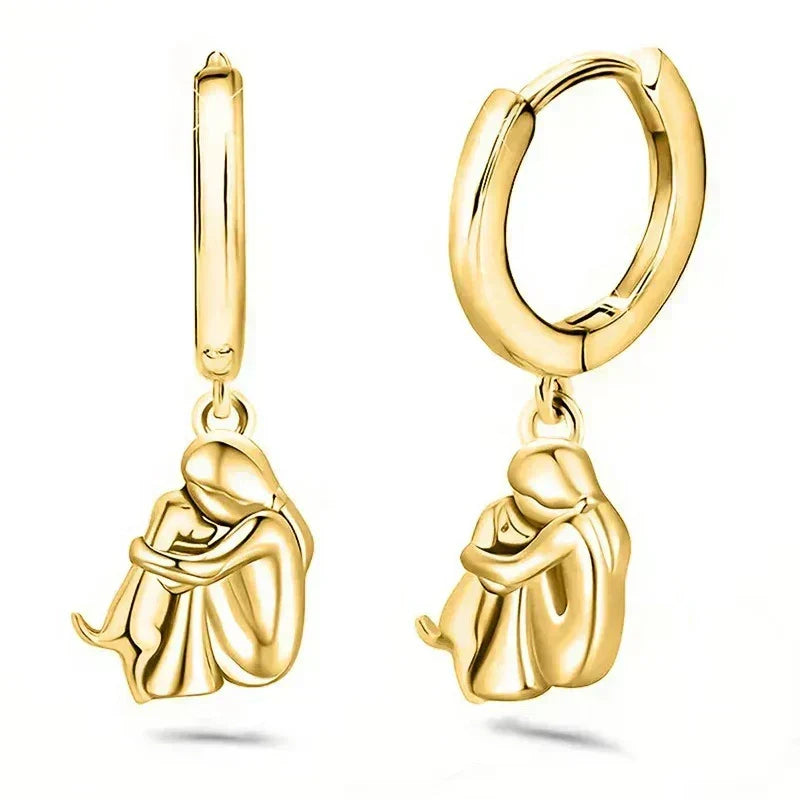 Seleno dog icon earrings in gold, pair shown upright