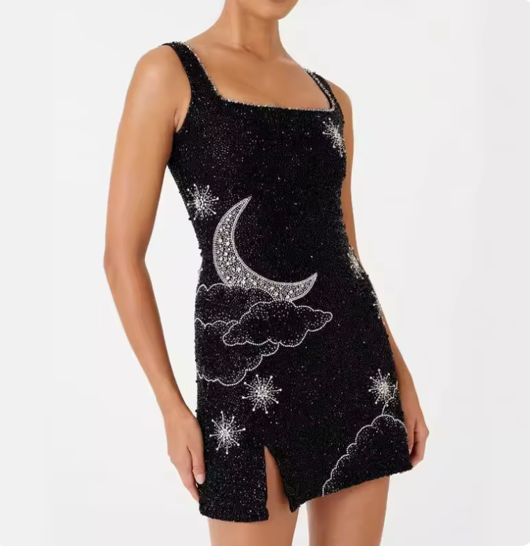 Phoebe sequin mini dress in black, close view of thigh slit and star detail