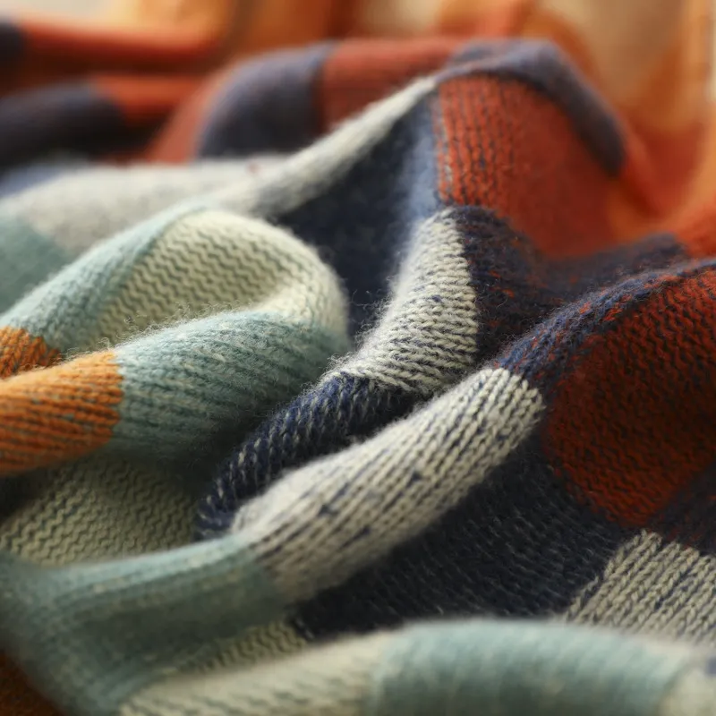 Close-up of Selvianne sweater knit texture in rust, teal and navy check