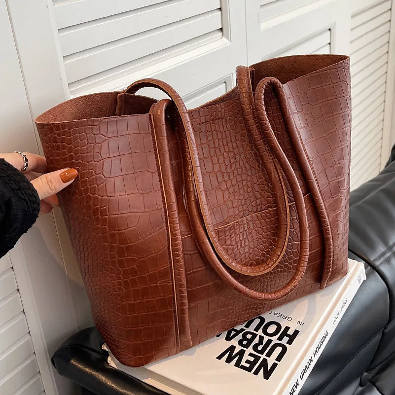 Sylvette croc shoulder bag in brown, side view with handles