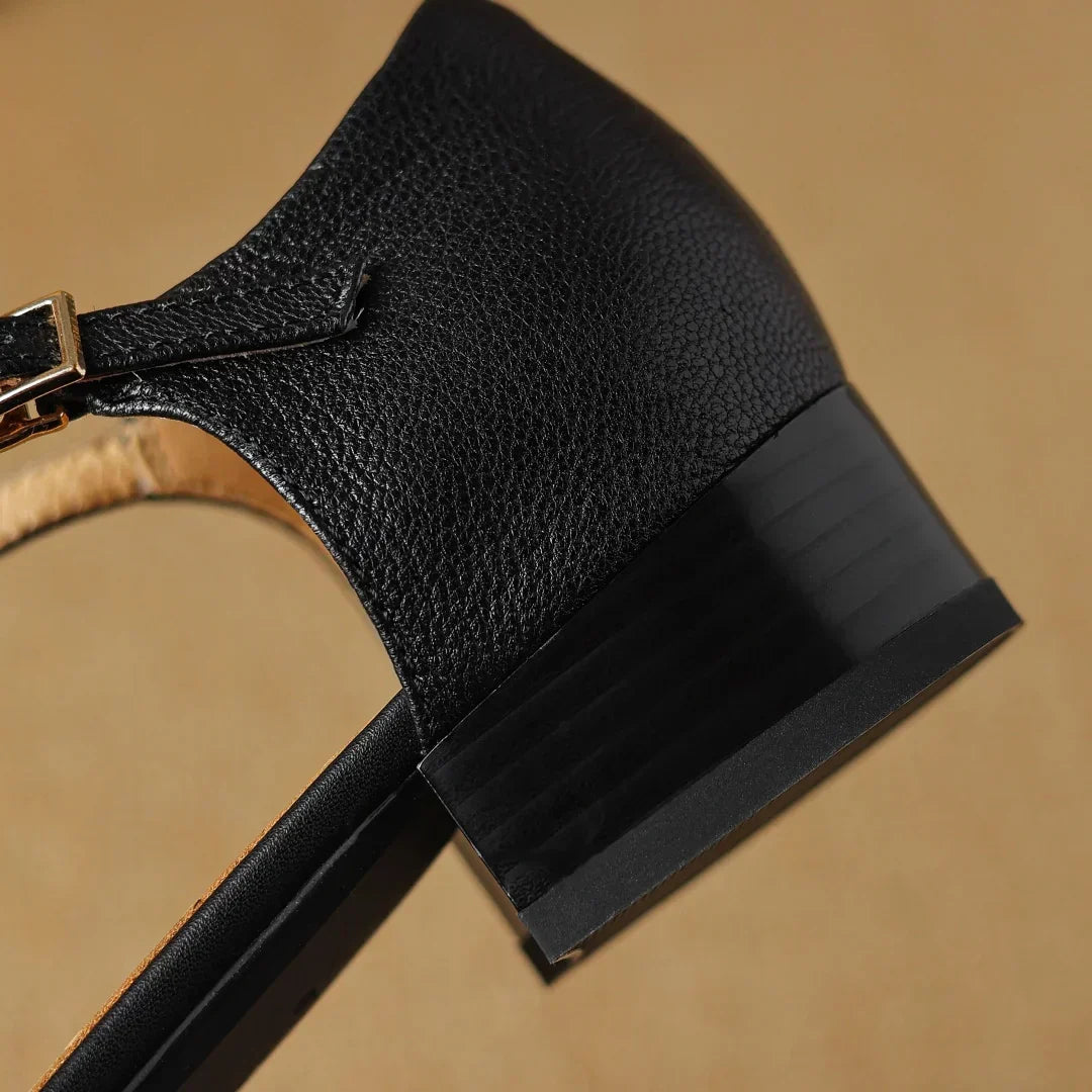 Joan T-bar flats in black, close-up of low block heel and buckle