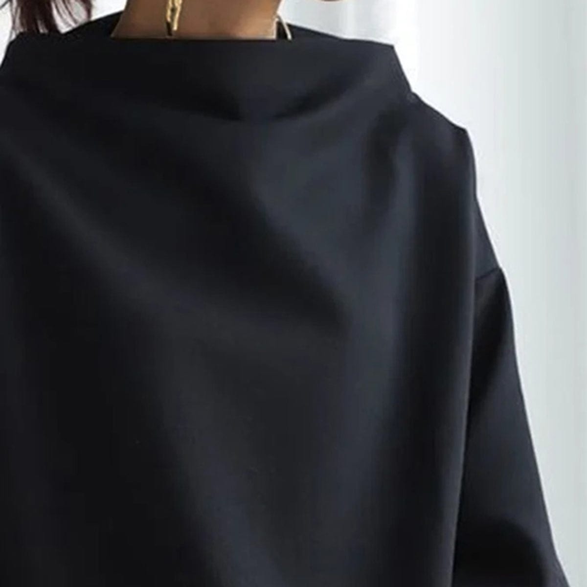 Elspeth high-neck casual top in black, close-up of the high neckline