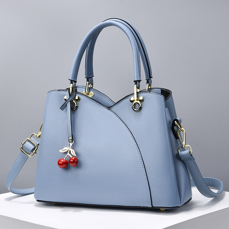 Avyra cherry tote bag in light blue, front view