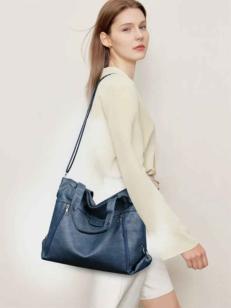 Model wearing retro shoulder tote bag in lake blue as a crossbody