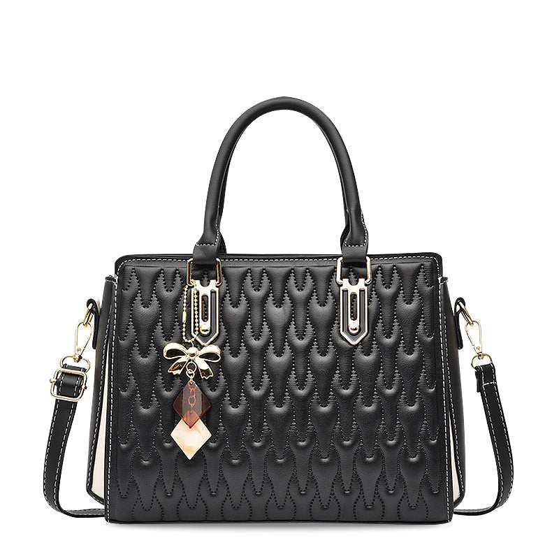 Vellora structured shoulder handbag in black, front view with gold bow charm