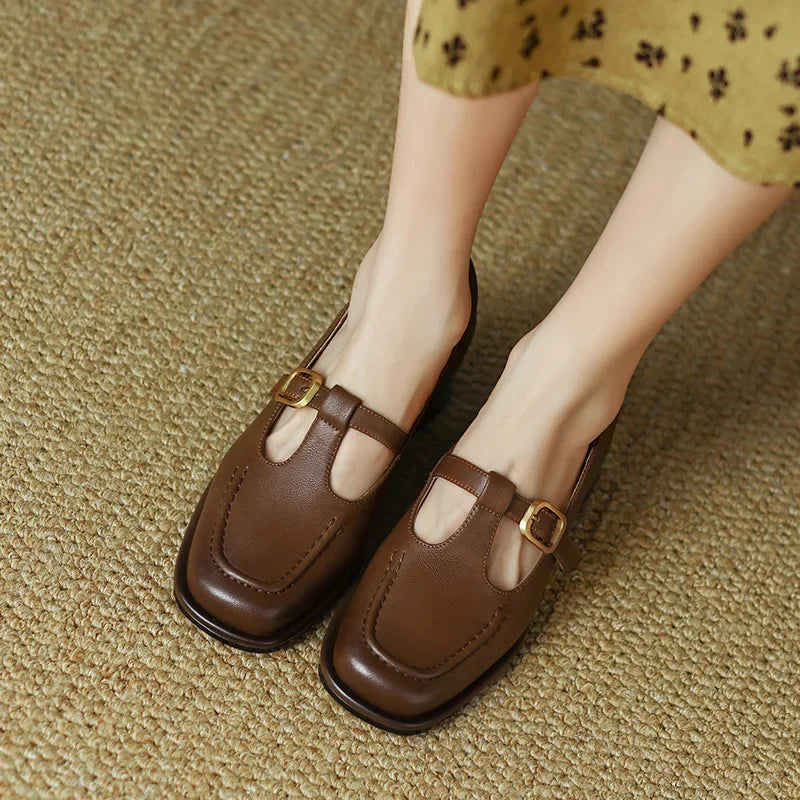 Selvana T-strap shoes in brown, front view worn with a yellow floral dress