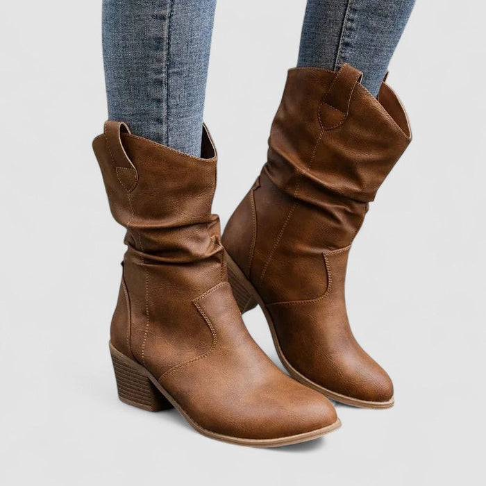 Eleanora slouch heeled boots in brown, worn with jeans, front view