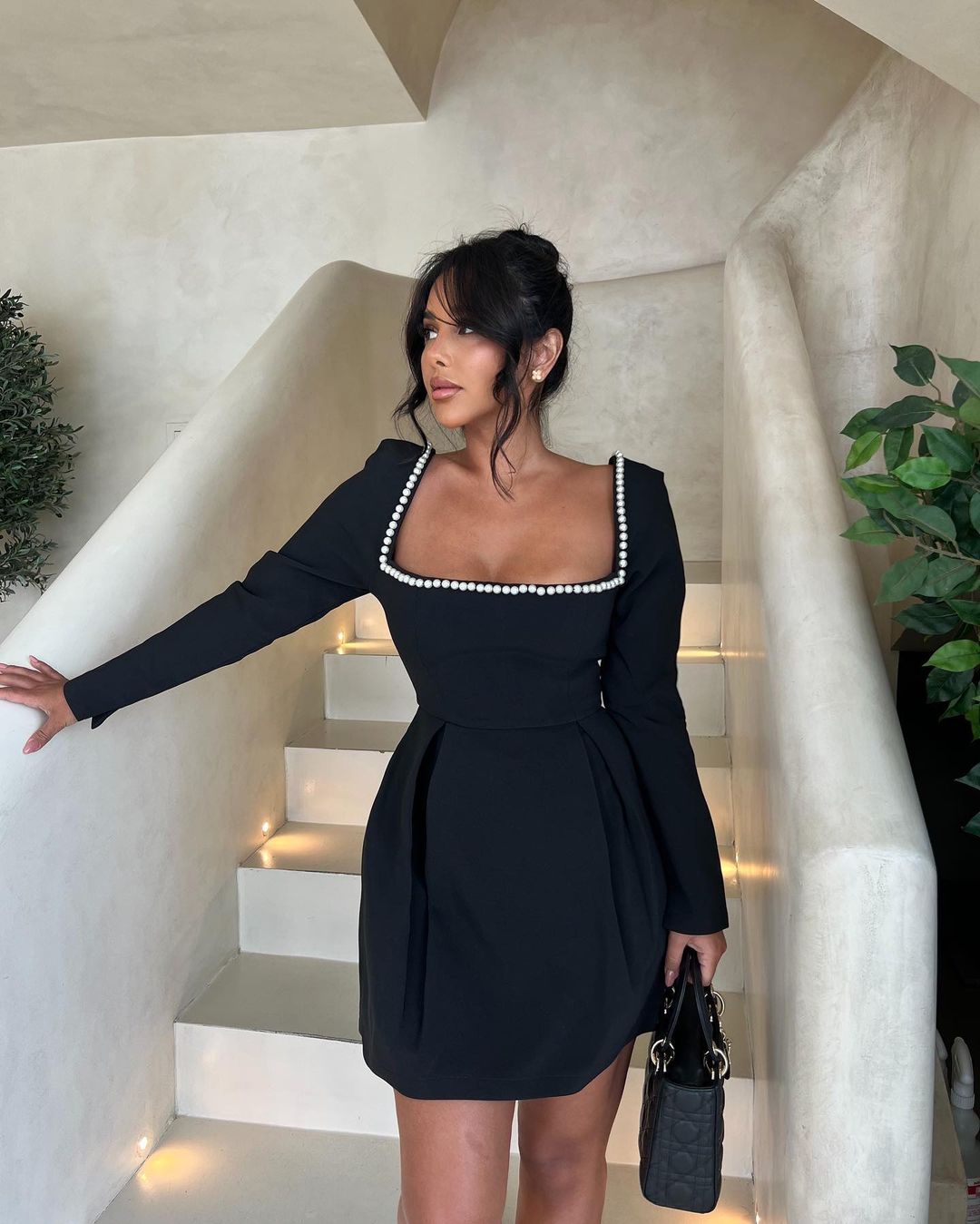 Elliott pearl dress in black, front view showing pleated skirt