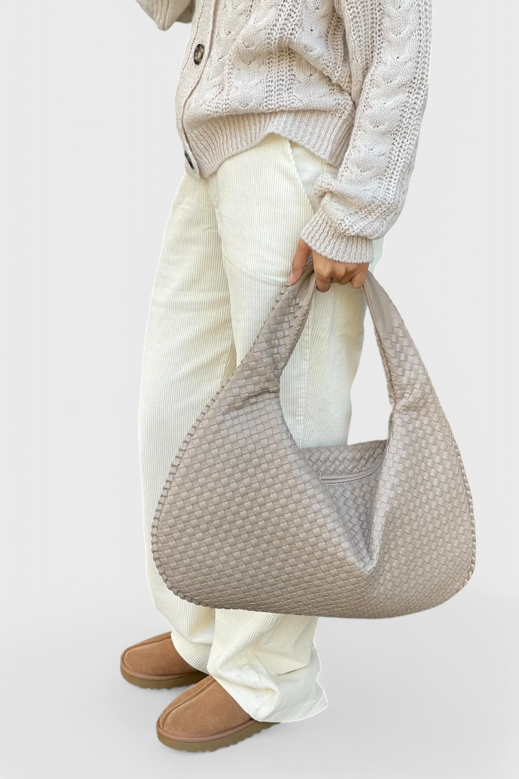 Tilly knitted shoulder bag in beige, held by model