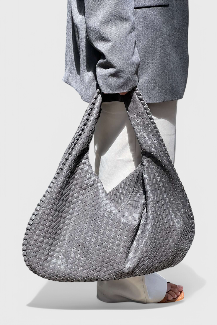 Tilly knitted shoulder bag in grey, held over the arm