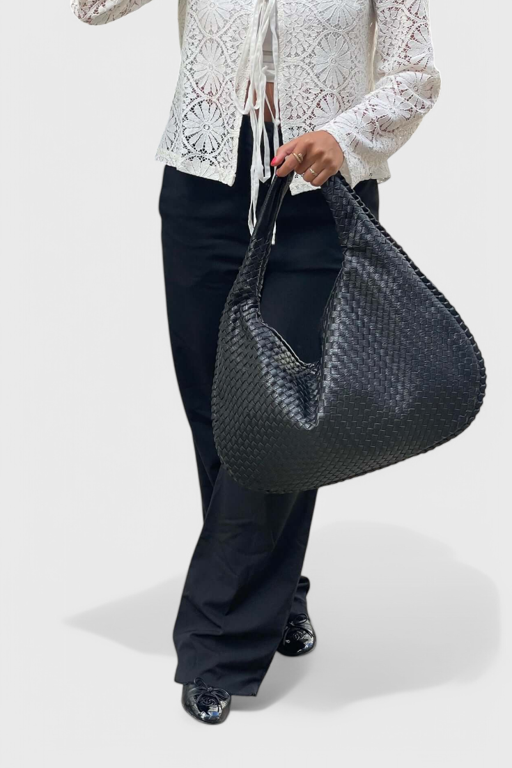 Tilly knitted shoulder bag in black, worn with black trousers