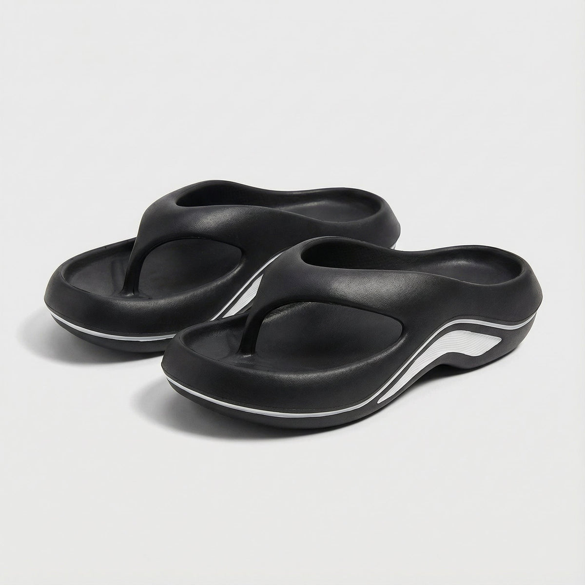 Juliette slide sandals in black with white trim, angled pair view