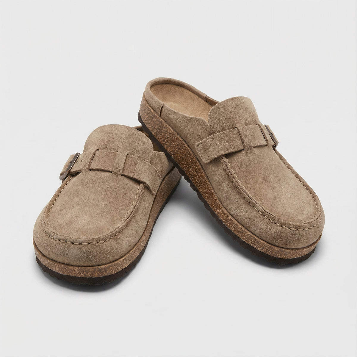 Kendra backless buckle clogs in beige, angled pair view