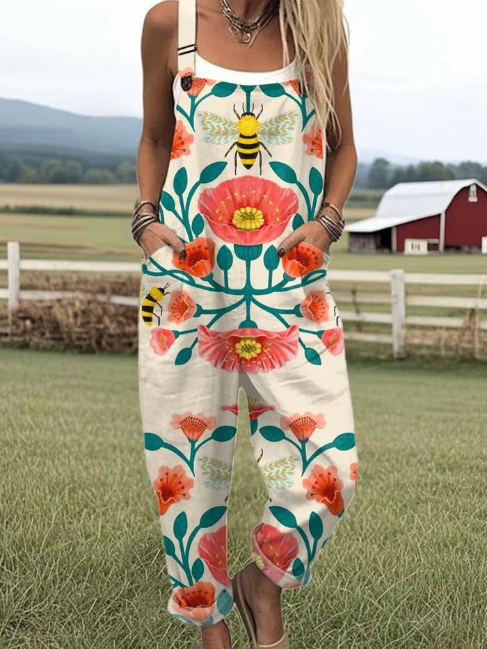 Honey Bloom dungarees in cream with coral floral and bee print, full-length front view