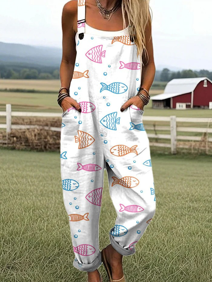 Ocean Whimsy dungarees in white with multicoloured fish print, full-length front view