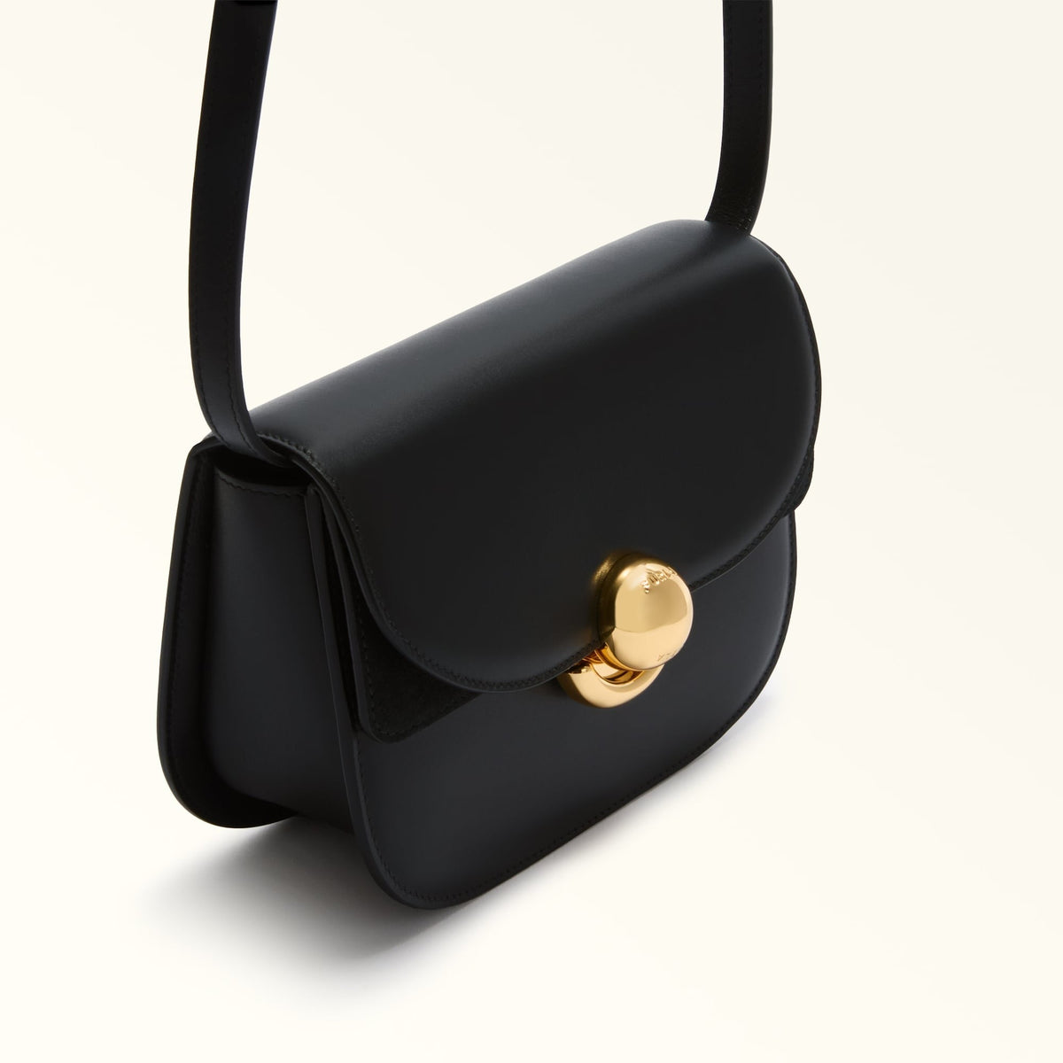 Zanélle mini shoulder bag in black, close-up of rounded flap and clasp