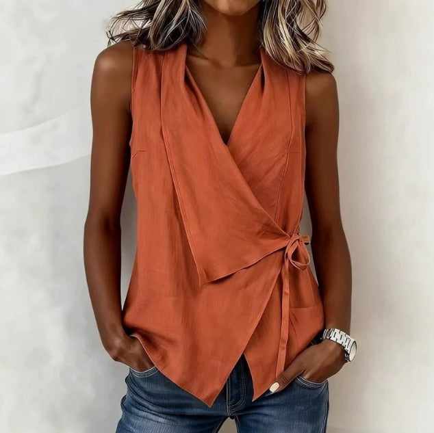 Loretta sleeveless wrap blouse in orange, front view with side tie