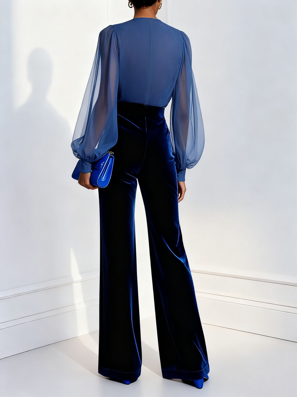 Celeste velvet jumpsuit in blue, back view showing wide-leg trousers