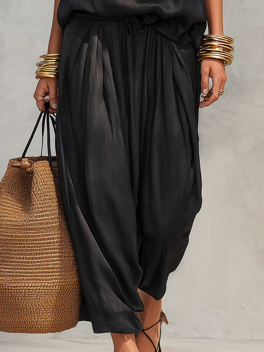 Serena set in black, close-up of pleated drawstring wide-leg trousers