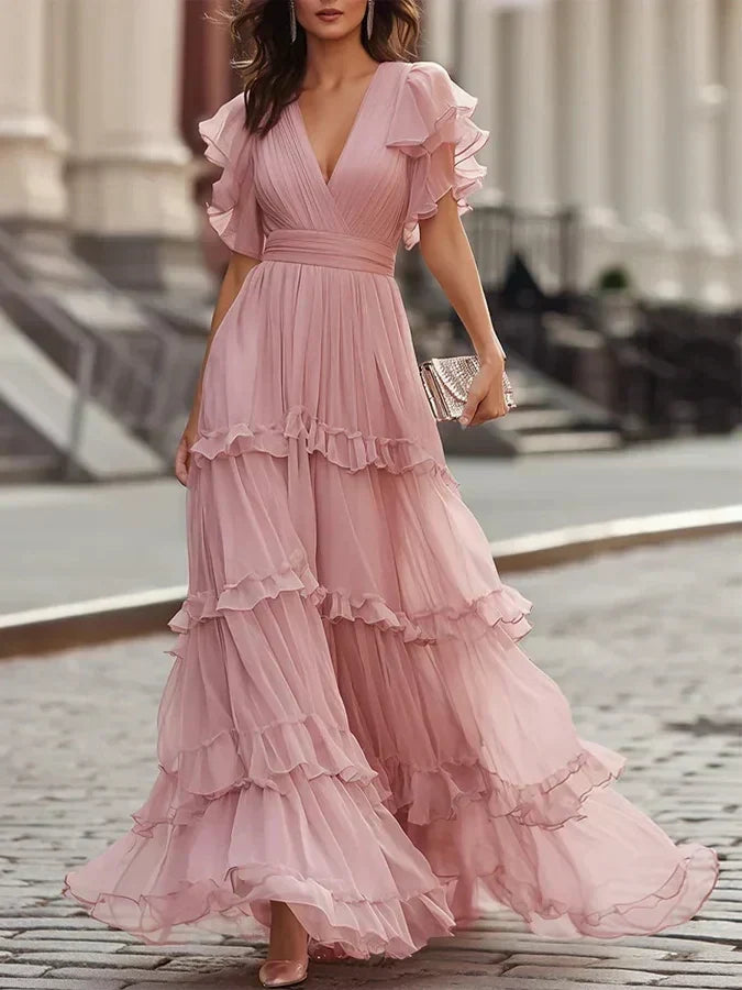 Charlotte tiered maxi dress in blush pink worn on a city street, front view
