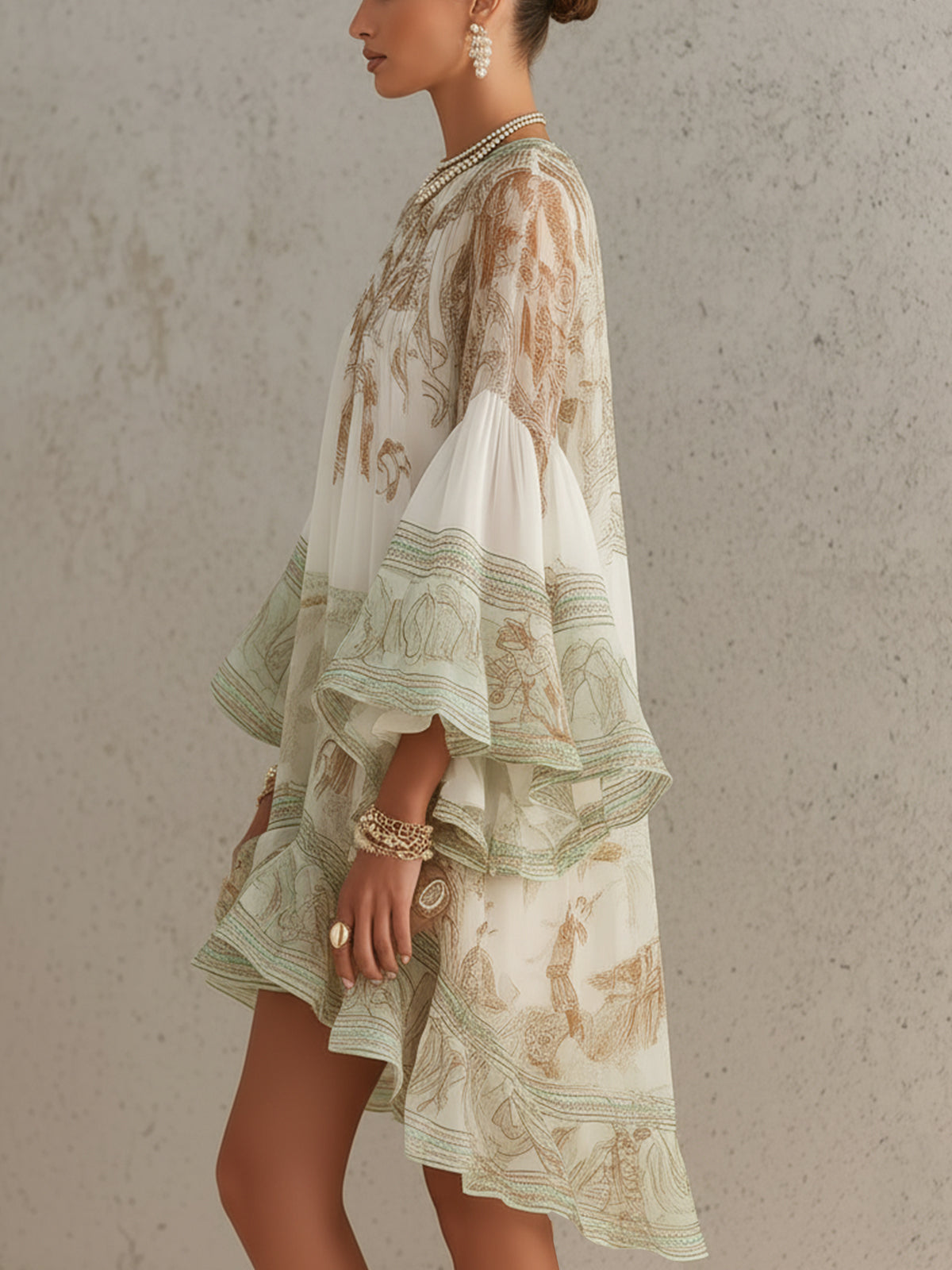 Rosalie printed mini dress in green and ivory, side view showing flowing hem