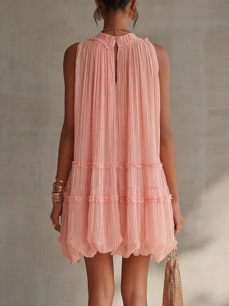 Magdalena pleated mini dress in pink, back view showing tiered ruffles