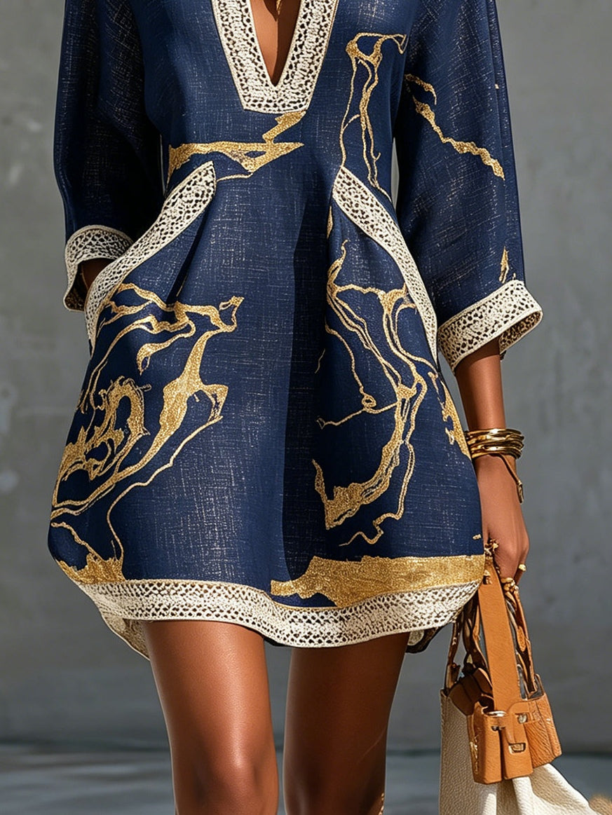 Cosette navy dress detail showing gold marbled print and lace hem border