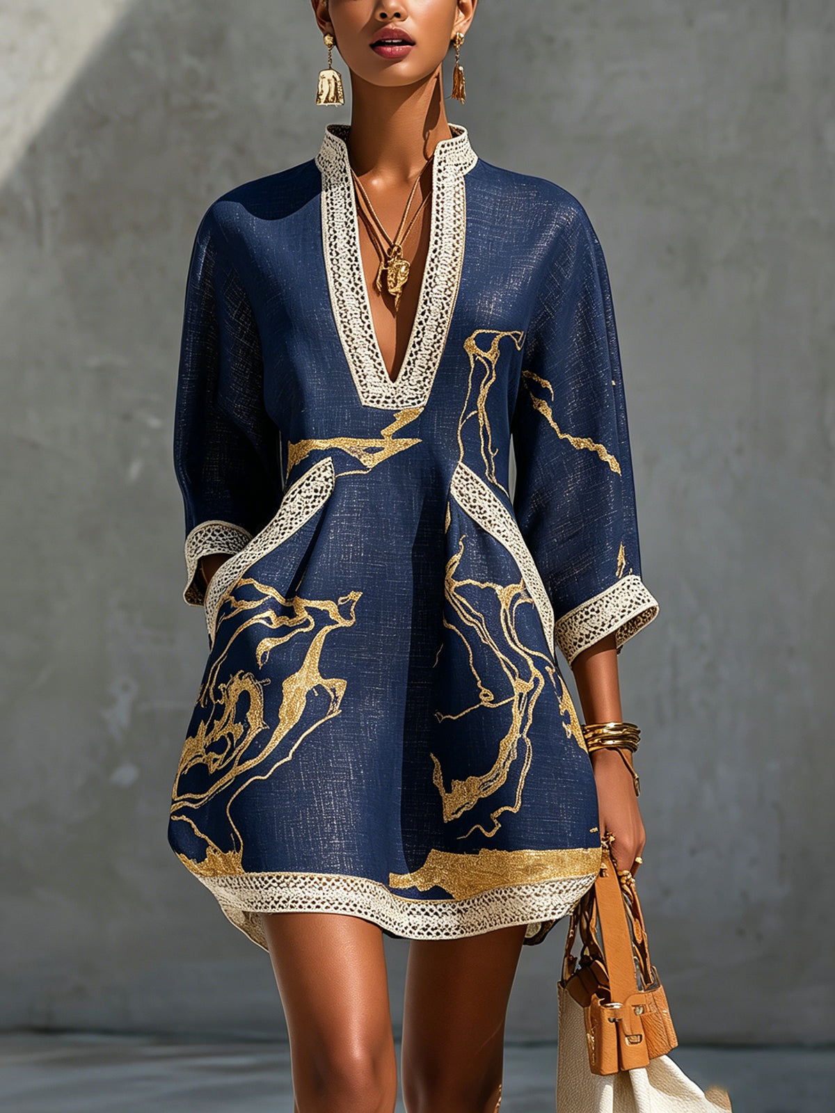 Cosette navy mini dress with gold print and crochet lace, front view