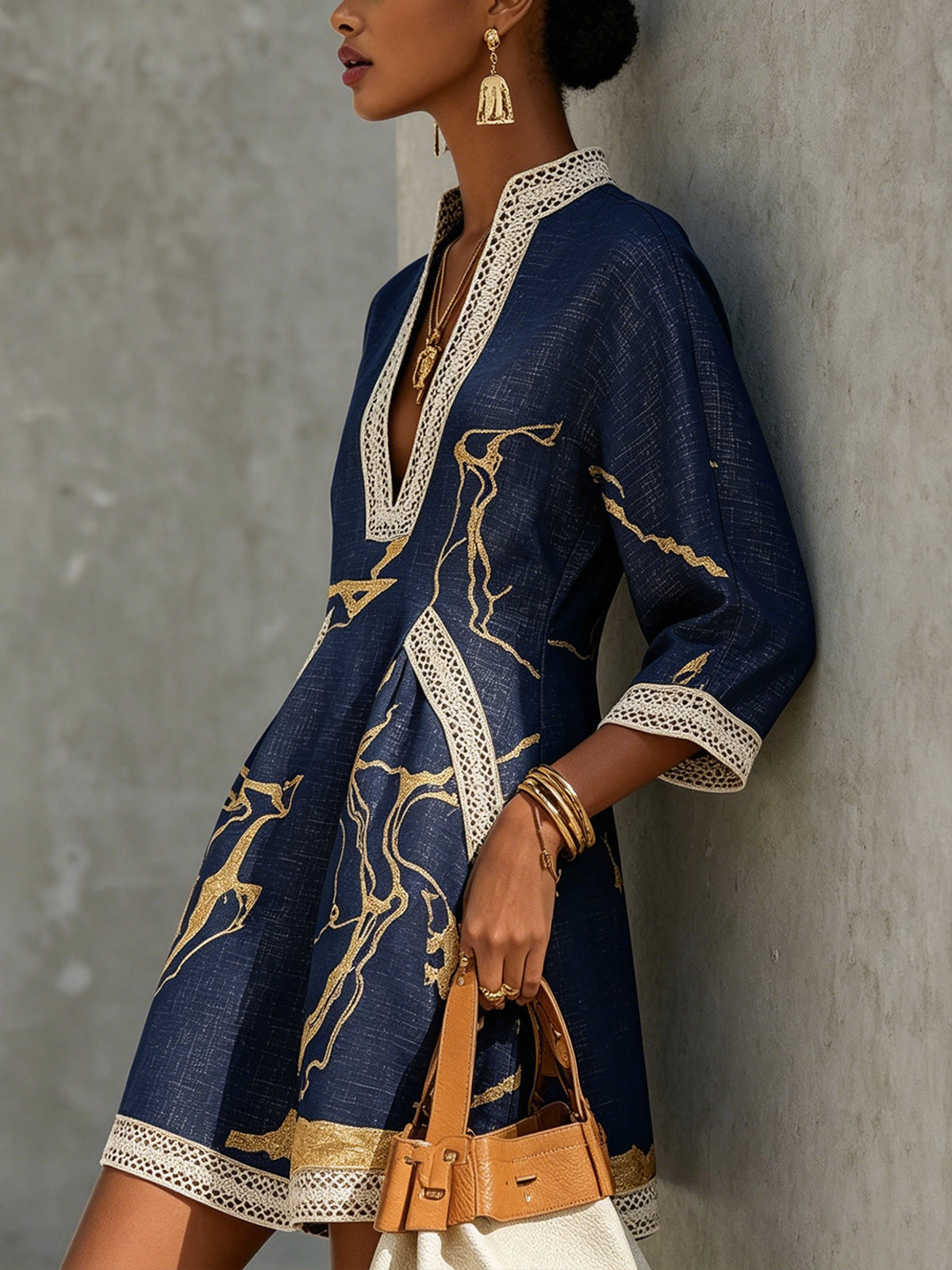 Cosette navy mini dress in gold print, side view showing lace hem