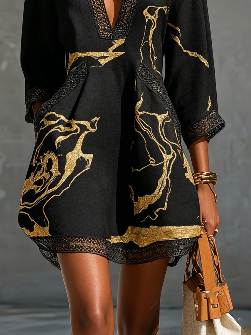 Léonie black and gold mini dress, close-up of flared hem and lace border