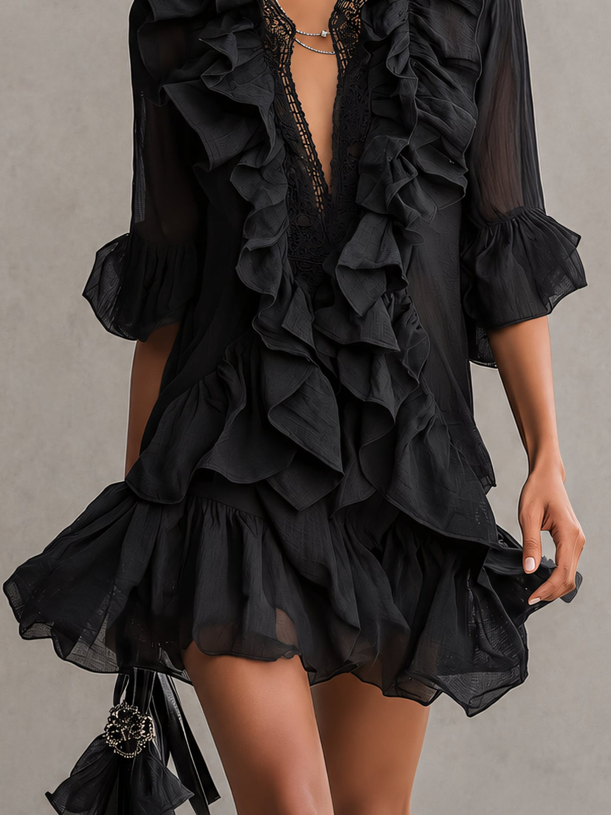 Anaïs black ruffle mini dress, detail of flared sleeves and ruffled hem