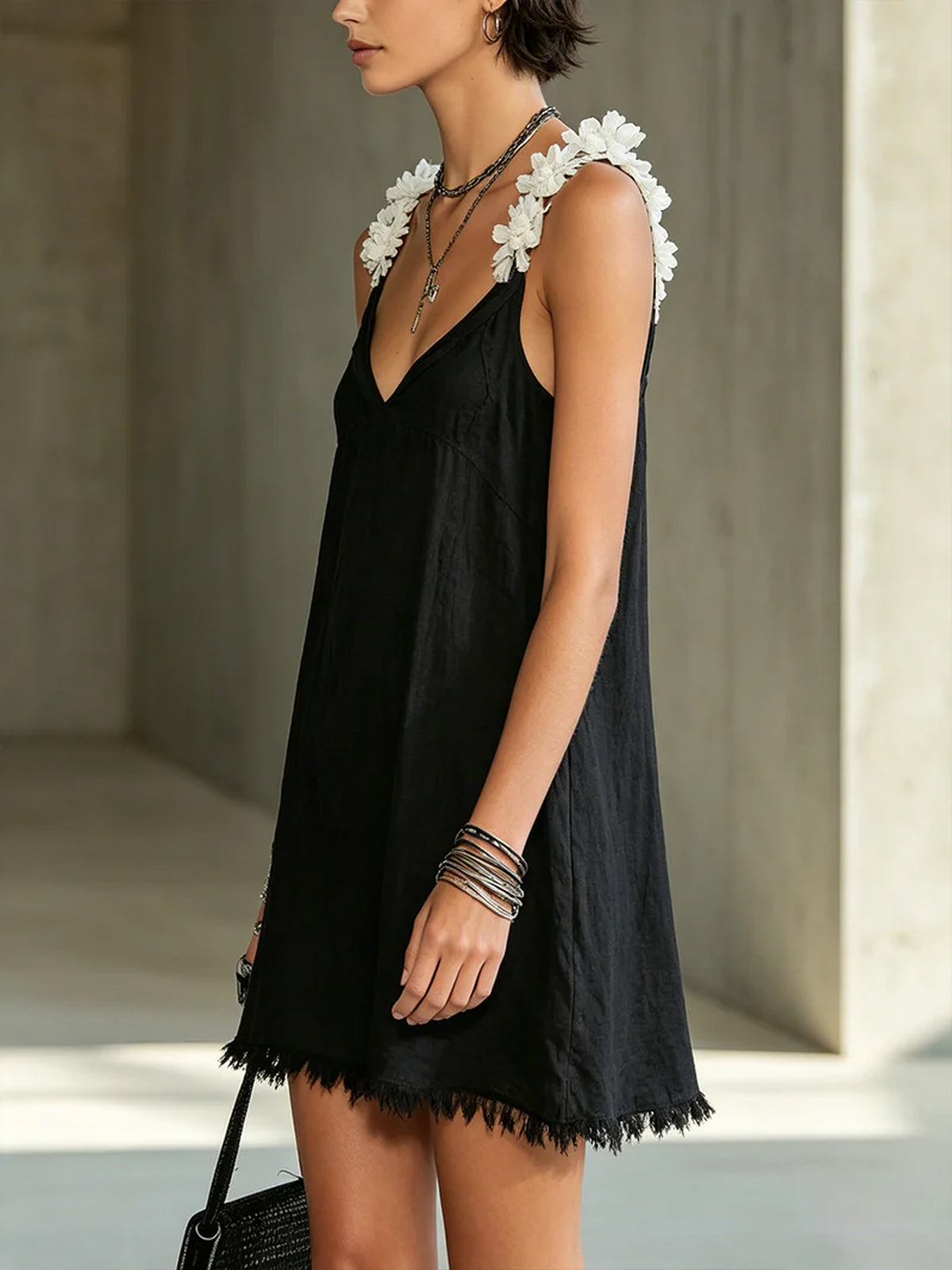 Noémie black mini dress, side view showing loose swing shape