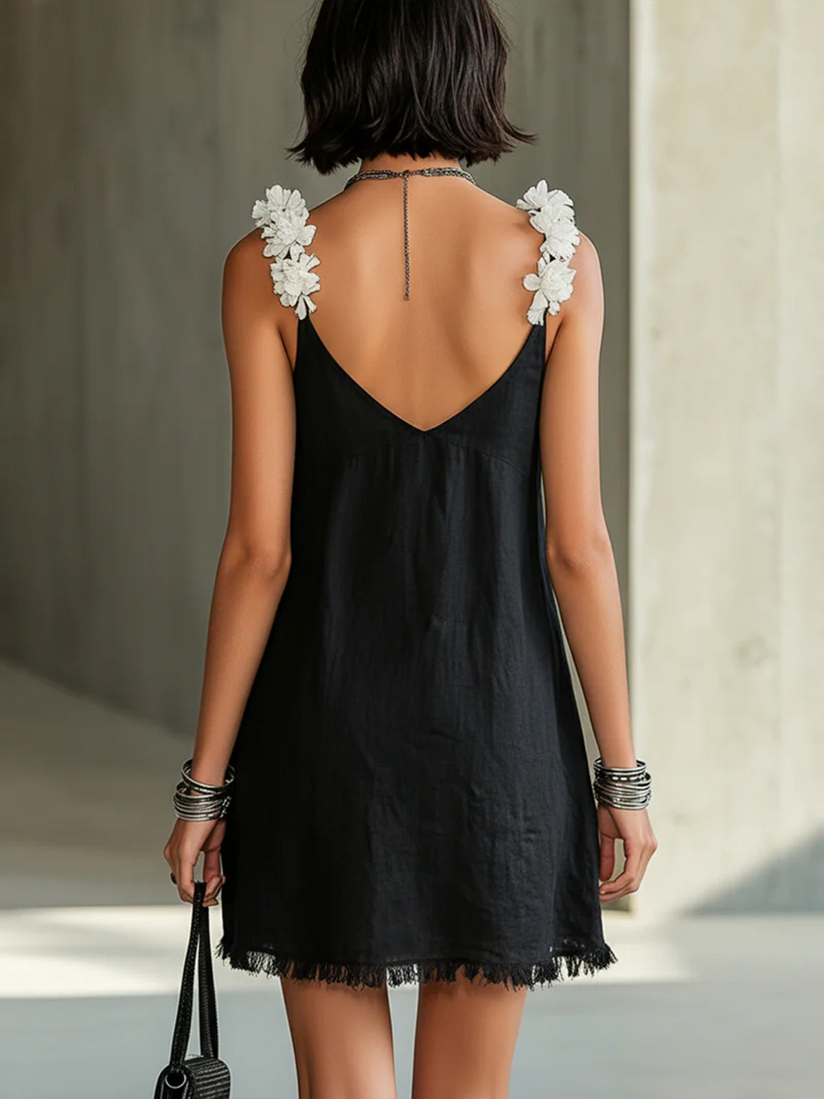 Noémie black mini dress, back view with V-shaped back