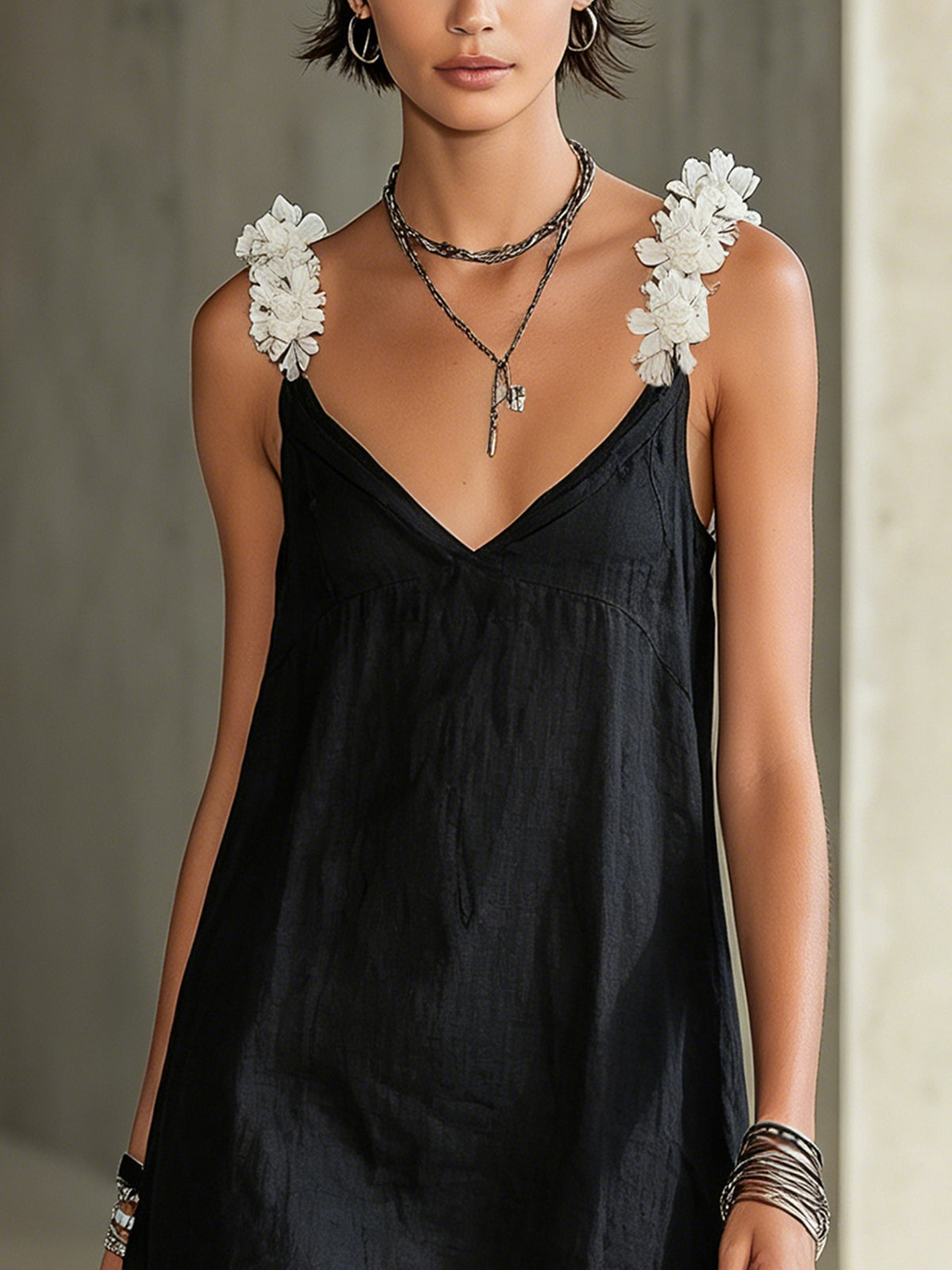 Close-up of ivory floral shoulder straps on Noémie black dress
