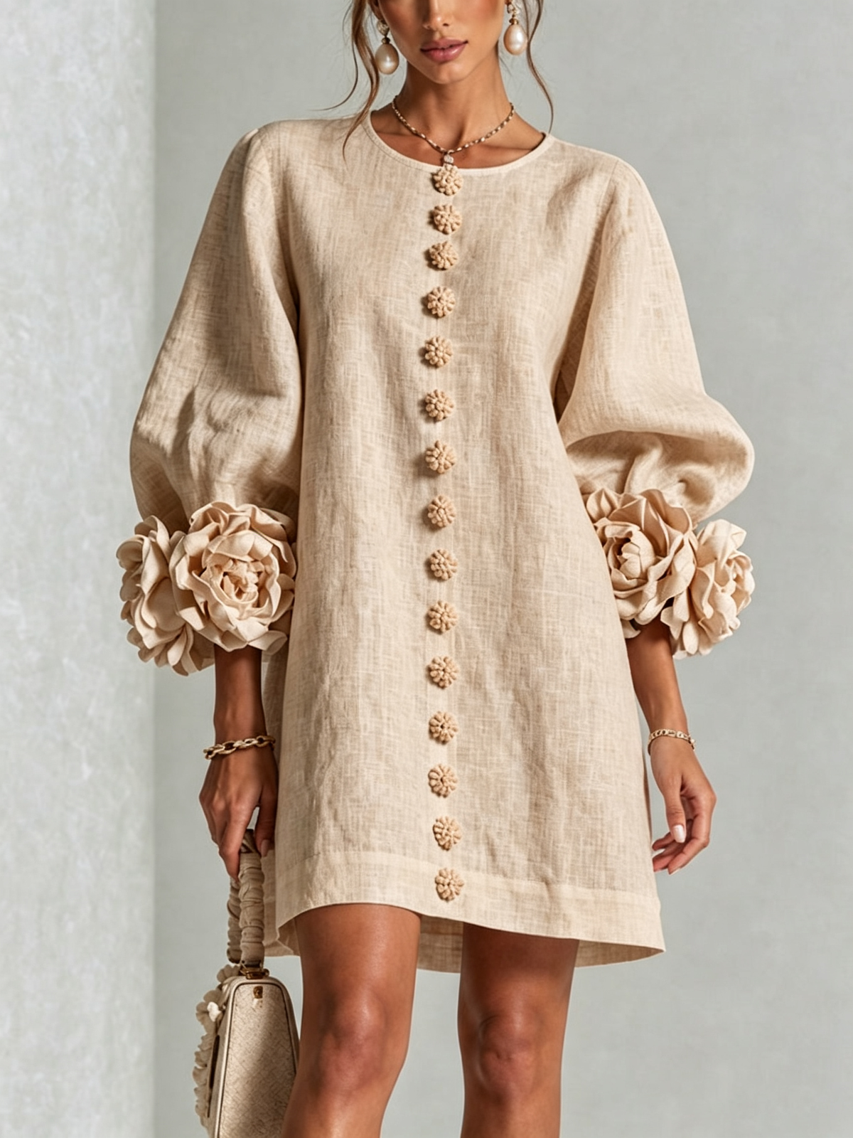 Ambra relaxed mini dress in beige, front view with floral buttons and rose cuffs