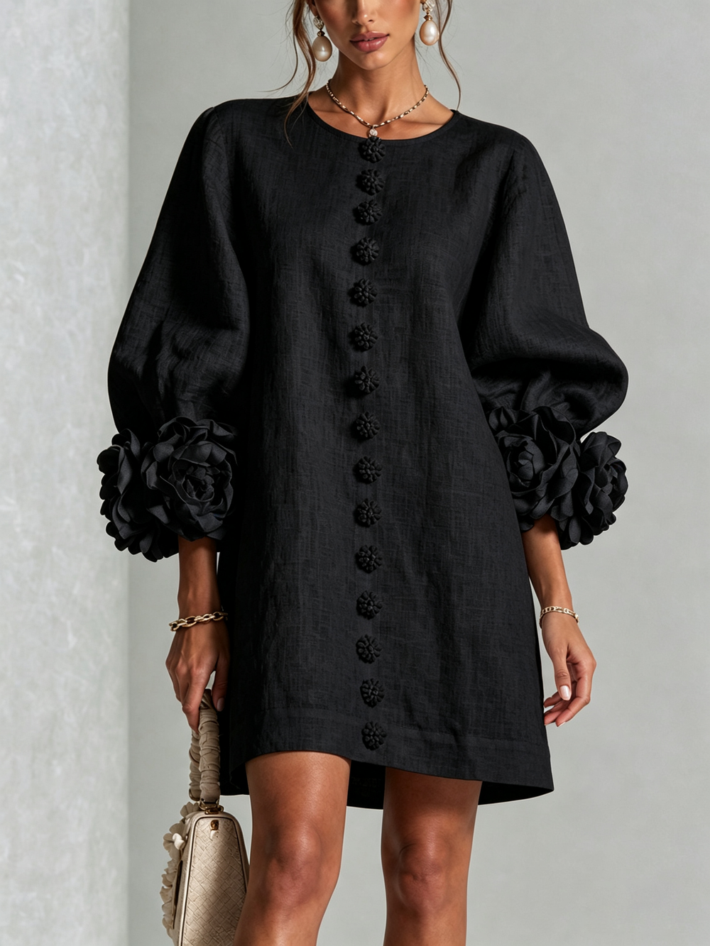 Cecilia relaxed mini dress in black, front view with floral buttons and rose cuffs
